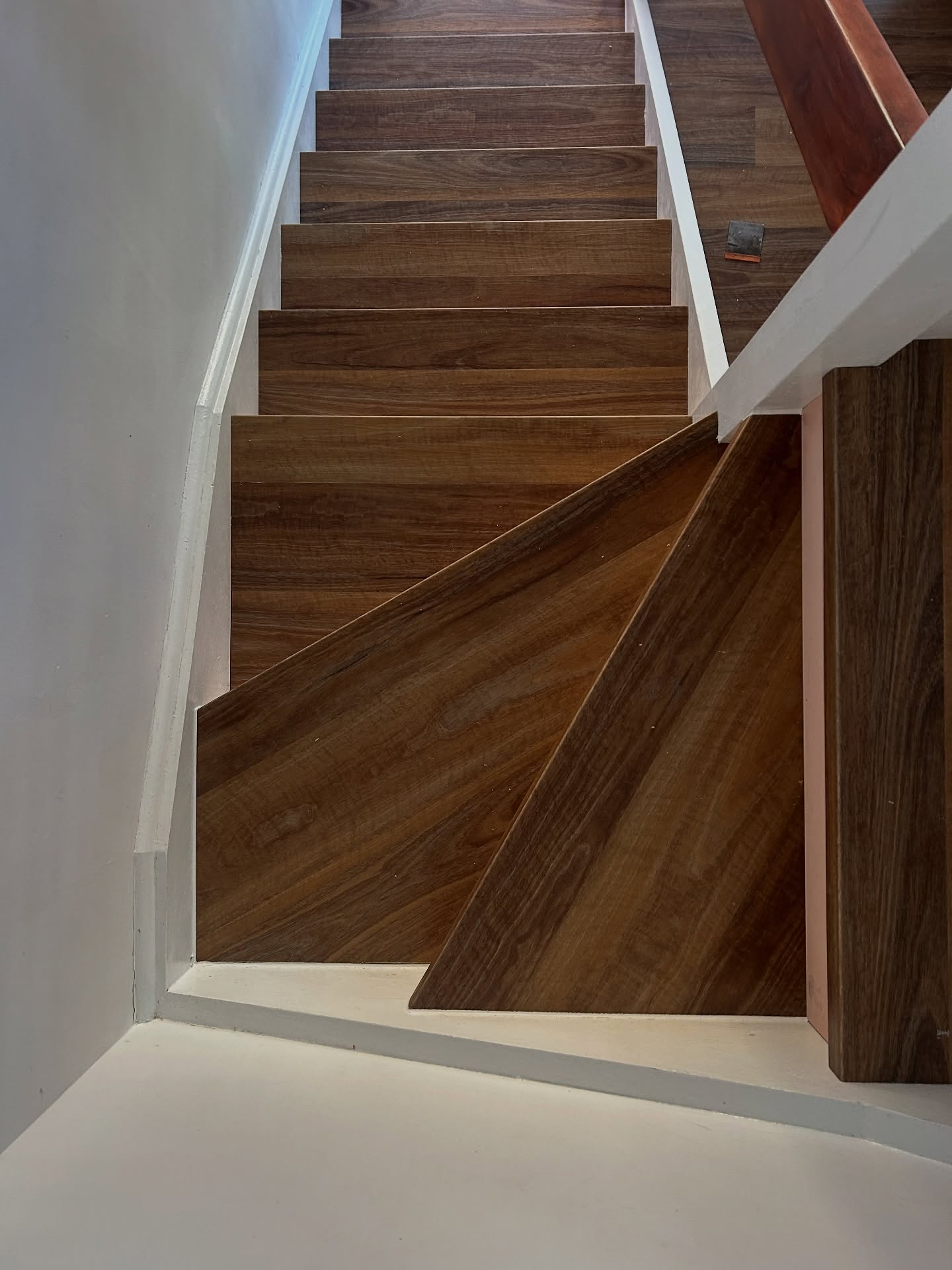 Hardwood stair treads installed by BJA Built, viewed from the landing