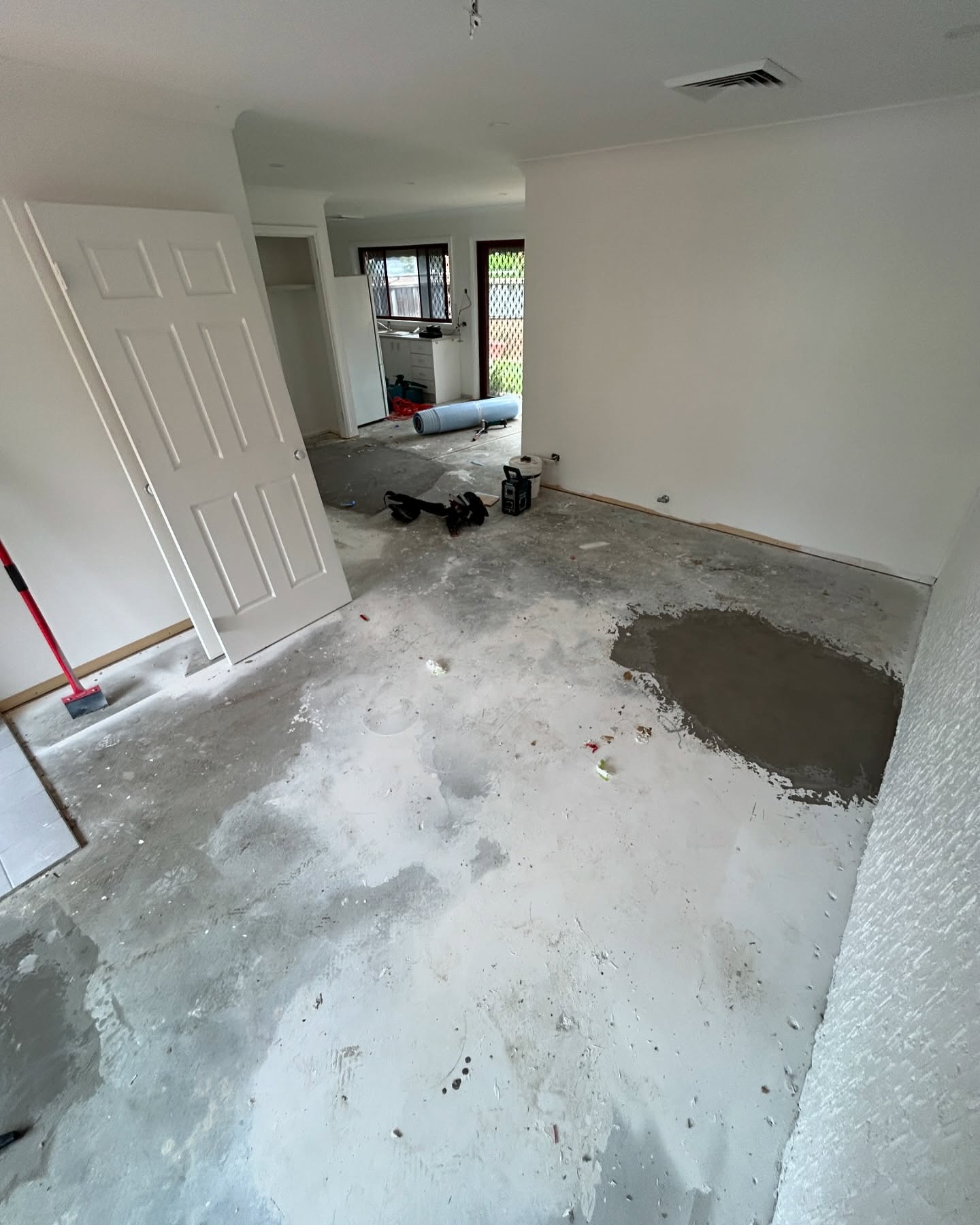 Stripped concrete slab before BJA Built installed new flooring